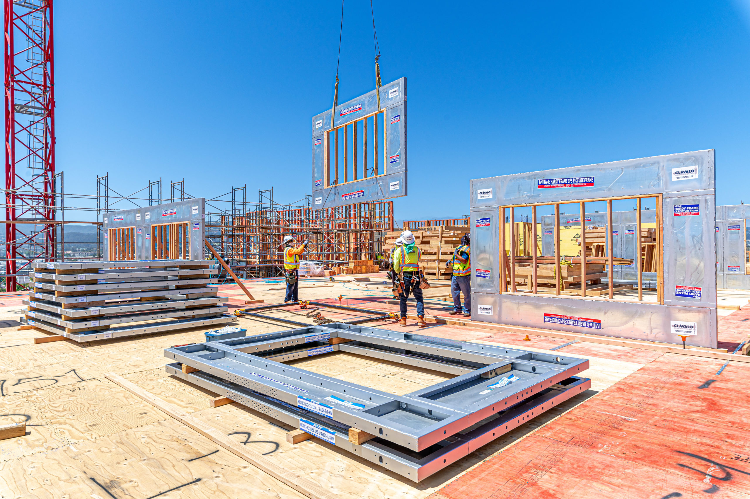 Design Make Build Prefabrication - Crew hoists prefabricated wall panel into place