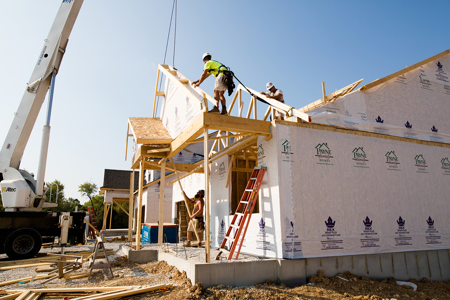 Homebuilding Solutions Press Release by MiTek - View of a wooden truss being installed in a residential, single-family home