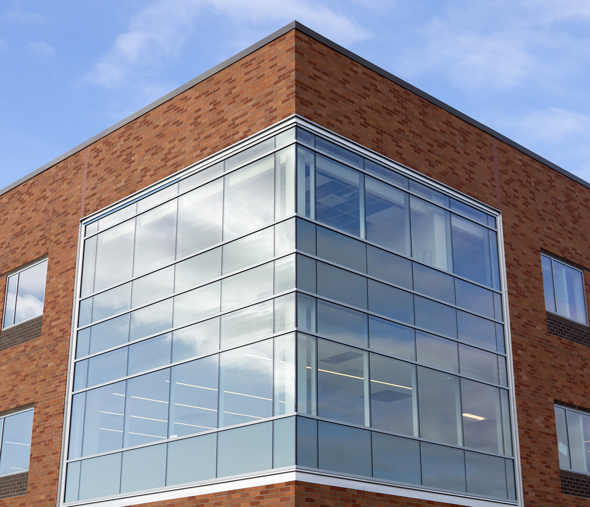 Benson Glass Engineered Systems Products - Corner of a brick and class building