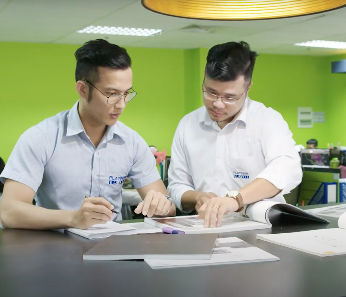 MiTek Execution Management Services - Two men at standing desk working on estimating