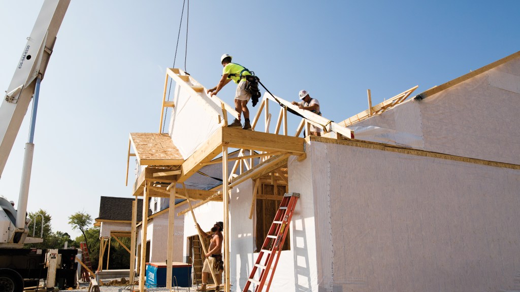 Homebuilding Solutions Press Release by MiTek - View of a wooden truss being installed in a residential, single-family home